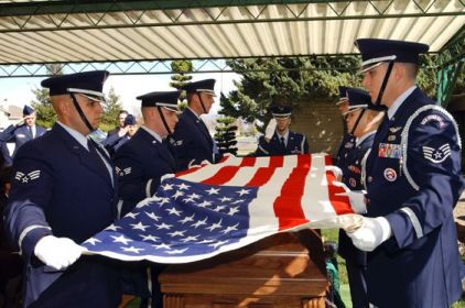 Members of the 
Travis Air Force Base Honor Guard performs a military flag folding in 
honor of Senior Airman Alecia Sabrina Good