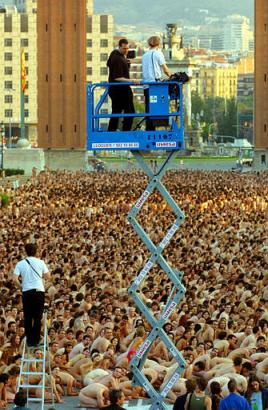 U.S. photograher Spencer Tunick, seen on elevated platform at left, prepares to photograph a gathering of over 7,000 naked people at daybreak in Barcelona, Spain Sunday June 8, 2003. Tunick gathered together a sea of nudes covering a central Barcelona avenue, his largest work yet. Photo by Pascual Gorriz