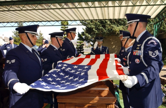 Members of the 
Travis Air Force Base Honor Guard performs a military flag folding in 
honor of Senior Airman Alecia Sabrina Good