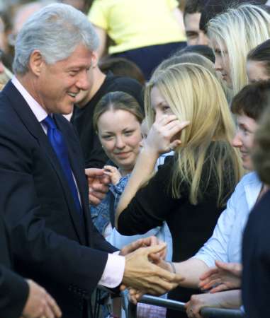 Former U.S. President Bill Clinton meets local people during a visit to Enniskillen, Northern Ireland, June 5, 2002. Clinton was opening a peace center in the town where an IRA bomb killed 11 people in 1987. Photo by Paul McErlane