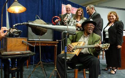 Rhythm and blues entertainer Bo Diddley records on a 125-year-old wax cylinder phonograph on Capitol Hill Wednesday, Sept. 17, 2003. In the background are, left to right, Rep. Joseph Crowley, D-N.Y., Rep. Mary Bono, R-Calif., John Conyers, D-Mich., and Rep. Linda Sanchez, D-Calif. Photo by Dennis Cook