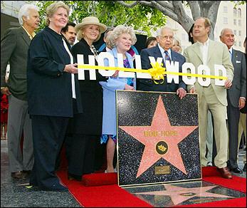 Celebrities and dignitaries pose with a special plaque naming entertainer Bob Hope as 'Citizen of the Century' during a dedication ceremony on the Hollywood Walk of Fame15 April, 2003 in Hollywood,. They are, from left (only visible), singer Jack Jones, Hope's daughter Linda Hope, comedian Dennis Miller, actress Eva Marie Saint, comedian Phyllis Diller, actress Cindy Williams, Honorary Mayor of Hollywood Johnny Grant, actress Connie Stevens, comedian Kelsey Grammer and producer A.C. Lyles.  Photo by Lee Celano