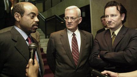 Irish rock star Bono, right, and U.S. Treasury Secretary Paul O'Neill talk with the Prime Minister of Ethiopia Meles Zenawi in Addis Ababa, Ethiopia, Wednesday, May 29, 2002. Photo by Sayyid Azim