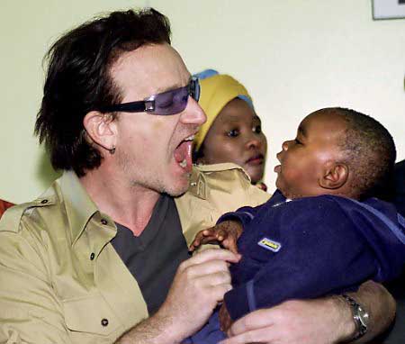 Irish rock star Bono plays with 11-month-old HIV-positive baby Thomas Gqubile, during a visit to South Africa's HIV-AIDS clinic at the hospital in Soweto, May 24, 2002. Photo by Juda Ngwenya