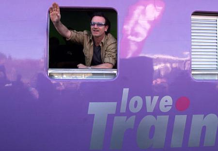 U2 pop star Bono waves aboard the ''Love Life'' train in Soweto, South Africa, Friday May 24, 2002. The train is used to educate people on AIDS as it tours the country. Photo by Themba Hadebe