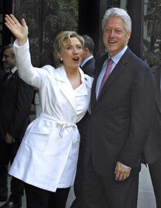 Sen. Hillary Rodham Clinton, D-N.Y., waves as she arrives with her husband, former U.S. President Bill Clinton, to her official book party for her memoir 'Living History' Monday, June 16, 2003, in New York. Photo by Tina Fineberg