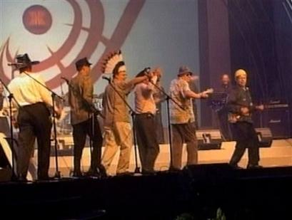 US Secretary of State Colin Powell, right, with other unidentified US diplomatic delegates perform a version of the Village People hit song 'YMCA' at the conclusion of Asia's largest security meeting in Jakarta, Indonesia, on Friday July 2, 2004. Powell took to the stage, dressed as a construction worker Friday, with other unidentified US diplomats to deliver their rendition of the 1970's hit song to an audience of Asia Security meeting delegates.