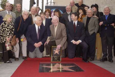 Comedian Dick Martin (C), flanked by 'Laugh-In' cast members, friends and family members, is all smiles after he and longtime co-host Dan Rowan (posthumous) were honored with the 2,194th star on the Hollywood Walk of Fame during an unveiling ceremony in Los Angeles April 2, 2002. Photo by Jim Ruymen