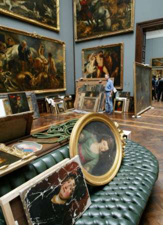 A man looks at paintings, piled in the famous art gallery Zwinger, which were saved from the rising floodwaters of the Elbe river, in the eastern city of Dresden August 16, 2002. A state of emergency was declared for the region after the worst flooding on record swamped large parts of Dresden and the surrounding area, leaving at least 10 people dead in Saxony. Photo by Alexandra Winkler