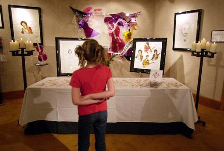 Taylor Thomas, age 9, of Houston, Tex., looks at artwork by John Entwistle, the bassist for The Who, Thursday, July 27, 2002 at the Grammy's Art of Music Gallery at the Aladdin Hotel and Casino in Las Vegas. Entwistle was to have been at the opening of his art show. Photo by Joe Cavaretta