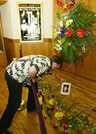 Las Vegas resident Craig Boyle places a picture of John Entwistle, at small memorial area just outside The Joint concert venue at The Hard Rock Hotel and Casino, Thursday, June 27, 2002, in Las Vegas. Photo by Eric Jamison