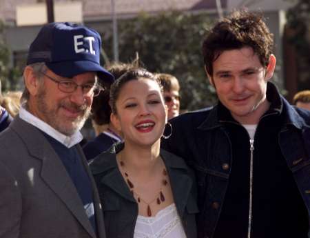 Director Steven Spielberg, Drew Barrymore and Henry Thomas (R) pose together as they arrive for the premiere of the 20th anniversary verison of their film 