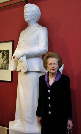 A May 21, 2002 photo from files of former British Prime Minister, Margaret Thatcher standing next to her larger than life marble statue when it was unveiled at the Guildhall Art Gallery in London.