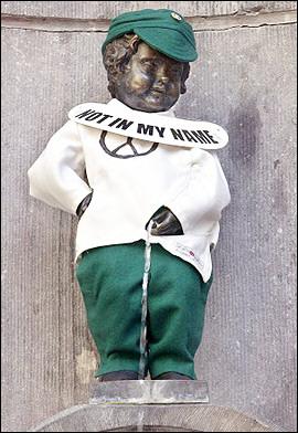 Brussel's famous statue Manneken Pis is dressed the colors of the city with a sign reading 'Not In My Name' referring to the US-led war in Iraq.  Photo by Benoit Doppagne