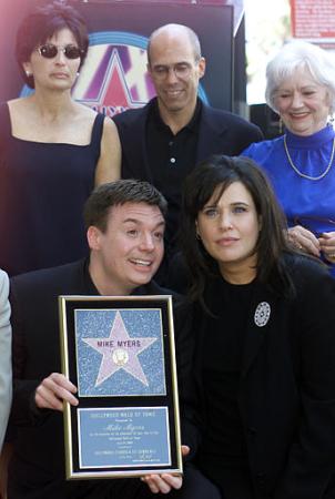 Comedian Mike Myers, center left, creator of the ''Austin Powers'' and ''Wayne's World'' franchise, holds a plaque commemorating his new star next to his wife Robin Ruzan, on the Hollywood Walk of Fame in the Hollywood section of Los Angeles Wednesday, July 24, 2002. Behind are from left Marilyn Katzenberg and husband DreamWorks co-founder/producer Jeffrey 'Sparky' Katzenberg, and Mike Myers' mother Alice Myers. Photo by Damian Dovarganes