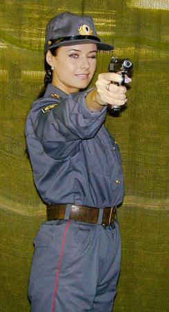 Newly crowned Miss Universe Oxana Fedorova, aims a pistol during a training in St. Petersburg, Russia in this April 18, 2001 file photo. Fedorova is a police lieutenant and is studying law at the St. Petersburg Police Academy. Fedorova's victory - the first Miss Universe from Russia - led nationwide newscasts Thursday, May 30, 2002. Photo by Igor Akimov