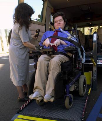 Nick Dupree, right, is helped from a van by his mother, Ruth Belasco, as he arrives at the Federal Courthouse in Montgomery, Ala., Tuesday, Feb. 11, 2003. Dupree, a quadriplegic from Mobile, Ala., was due to lose home care services provided by Medicaid when he turns 21 this month, until a waiver for Alabama's seriously disabled Medicaid recipients was announced by the national Medicaid office Monday night. Photo by Jamie Martin