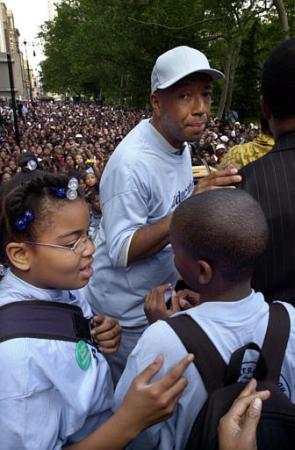 Hip Hop mogul Russell Simmons, center, prepares fifth graders from New York's Public School 77, to address thousands of New York City public school students at a protest rally near City Hall in New York, Tuesday June 4, 2002. Photo by Bebeto Matthews