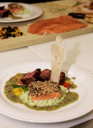 Sesame crusted salmon & roasted beef tenderloin with stir fried vegetables & an Oscar made from a rice cracker. Photo by Fred Prouser