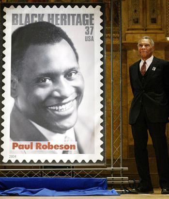 Paul Robeson Jr. poses next to the new addition of the Black Heritage Stamp Collection, his father Paul Robeson, in Princeton, N.J. on Tuesday, Jan. 20, 2004.  Photo by Tim Larsen