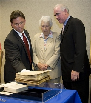 Jody Weis, left, Special Agent in Charge of the FBI Philadelphia Division, holds up the recently found original manuscript of Pearl Buck's 'The Good Earth' while Janice Walsh, center, the daughter of Pearl Buck and Patrick Meehan, United States Attorney for the Eastern District of Pennsylvania look on at a press conference at the U.S. Federal Building, Wednesday, June 27, 2007, in Philadelphia.  Photo by Tom Mihalek