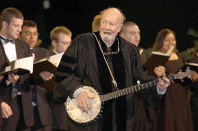 Folk singer Pete Seeger performs 'When the Saints Go Marching In' with the Saint Rose Chamber Singers during commencement ceremonies for the College of St. Rose at the Empire State Plaza in Albany, N.Y., Saturday, May 10, 2003. Seeger received a 'Special Recognition' honor at the event. Photo by Stewart Cairns