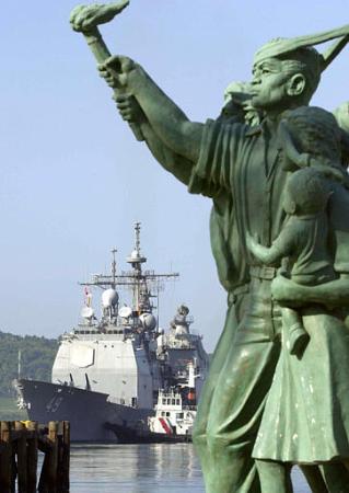 The USS Vincennes approaches the port ahead of the opening ceremony for the joint naval exercise between the Philippines and the United States known as Cooperation Afloat Readiness and Training, or CARAT, Wednesday, July 17, 2002 at the former American naval base in Subic, northwest of Manila. The statue in the foreground stands for Philippines' independence. Photo by Pat Roque