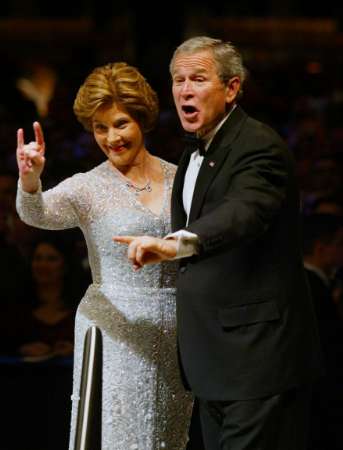 U.S. resident George W. Bush and his wife Laura gesture to audience at Commander In Chief's Ball honoring the inauguration of the president in Washington, January 20, 2005. The ball is being held for all members of the United States armed forces and is the last of many stops the President and his wife will make throughout the night. Photo by Shannon Stapleton