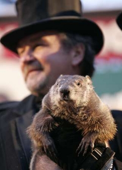 John Griffith, one of Punxsutawney Phil's handlers, holds the famous groundhog in the air after pulling him from his stump on Gobbler's Knob in Punxsutawney, Pennsylvania on February 2, 2007. Phil did not see his shadow which means a prediction of an early spring. Photo by Jason Cohn