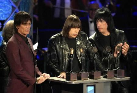 Johnny Ramone, center, is flanked by Marky Ramone, right, and Dee Dee Ramone of the punk rock group ''The Ramones,'' after being inducted into the Rock and Roll Hall of Fame Monday, March 18, 2002, at New York's Waldorf Astoria. Photo by Kathy Willens