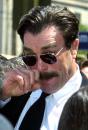 Tom Selleck wipes eye after service for Robert Urich. Photo by Lee Celano