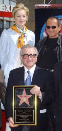 Director Martin Scorsese holds a replica plaque of his star after he was honored with the 2,217th star on the Hollywood Walk of Fame, during an unveiling 
ceremony in Los Angeles, California, February 28, 2003. Scorsese is nominated for a best director Oscar for his latest film, 'Gangs of New York,' which is also nominated for a best picture. Looking on are actors Sharon Stone (L) and Joe Pesci, who Scorsese directed in the 1995 motion picture 'Casino.' Photo by Jim Ruymen