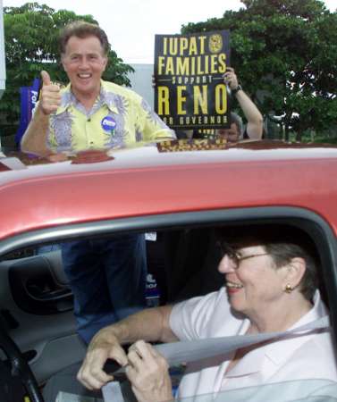 Actor Martin Sheen gives a thumbs up as he and Janet Reno prepare to leave a campaign stop in Deerfield Beach, Florida, June 8, 2002. Sheen, who plays a U.S. president on 'The West Wing' television series, is stumping for the former U.S. Attorney General during a four-day campaign and fund-raising tour around Florida. Reno is favored to become the Democratic gubernatorial candidate in September. If she wins she will go up against U.S. resident George W. Bush's brother, Republican incumbant Jeb Bush in a November election. Photo by Colin Braley