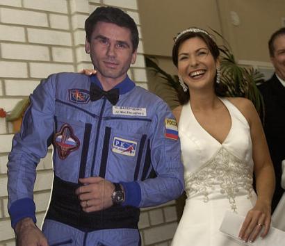 Ekaterina Dmitriev Malenchenko poses with a cardboard cutout of her new husband, cosmonaut Yuri Malenchenko, following a long distance wedding ceremony between the couple Sunday, Aug. 10, 2003, in Houston. The couple were married via satellite downlink between the International Space Station and NASA headquarters. Photo by Brett Coomer