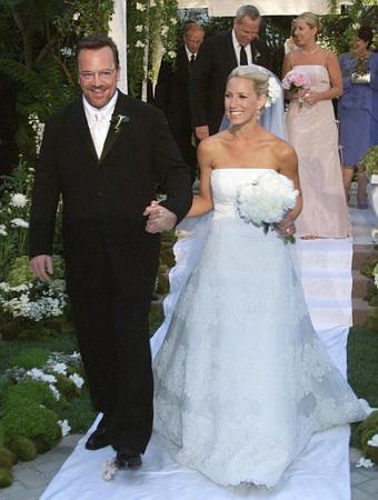 'Best Damn Sports Show Period,' host Tom Arnold walks down the aisle with his new wife, Shelby Roos, in a marriage ceremony Saturday, June 29, 2002, in Beverly Hills, Calif. Photo by C.Ferre