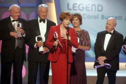 Comedienne Carol Burnett (C), star of the 'Carol Burnett Show,' accepts the legend award at the third annual TV Land Awards in Santa Monica, California March 13, 2005. Burnett and the cast of the 'Carol Burnett Show,' Harvey Korman, Lyle Waggoner, Burnett, Vicki Lawrence and Tim Conway, (L-R), were honored at the awards show, which will be telecast in the United States on the TV Land cable channel March 16.    Photo by Fred Prouser