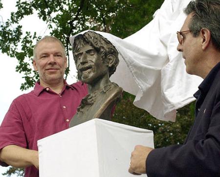 Bob Zappa, right, brother of the late rock musician Frank Zappa, and Wolfhardt Kutz, left, creator of the local Zappa fan club, The Arf Society, unveil a bronze bust of Frank Zappa on a stage in Bad Doberan, northeastern Germany, Saturday, July 27, 2002. The town of 12,000 is something of a magnet for Zappa freaks, and last weekend hosted its 13th annual Zappa festival. Photo by Thomas Haentzschel